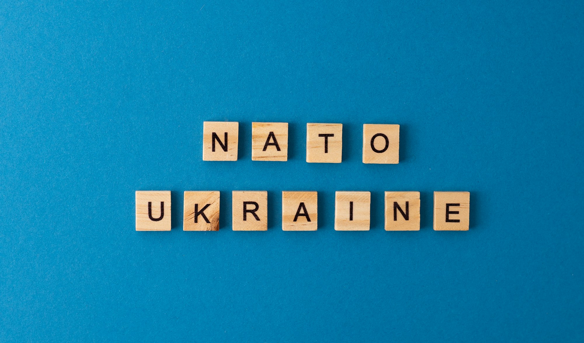 NATO Ukraine.The phrase is laid out in wooden letters. Top view. Motivation.